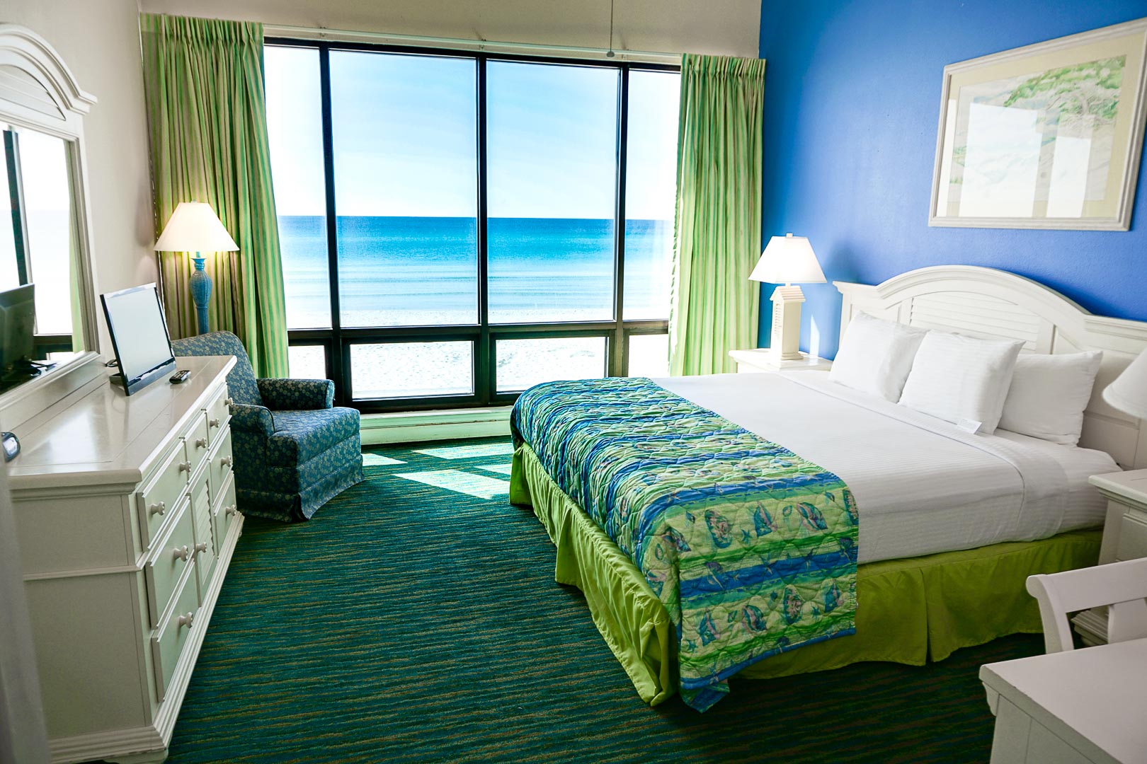 A beautiful master bedroom with a view to the beach at VRI's Landmark Holiday Beach Resort in Panama City, Florida.